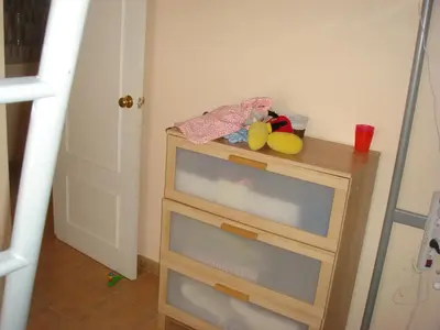 a wooden dresser with a toy on top of it at Chalet Pto Sta Maria, SOLO FAMILIAS in El Puerto de Santa María