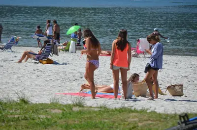a group of people standing on a beach at Chalet Pto Sta Maria, SOLO FAMILIAS in El Puerto de Santa María