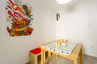 a small table and bench in a room with a painting at PASACALLES Home by Cadiz4Rentals in Cádiz