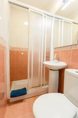 a bathroom with a shower and a toilet and a sink at PASACALLES Home by Cadiz4Rentals in Cádiz
