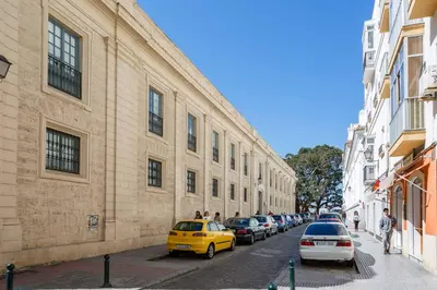 a street with cars parked on the side of a building at PASACALLES Home by Cadiz4Rentals in Cádiz