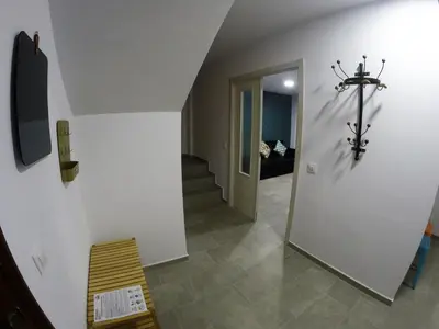 a hallway with a stairway with a cross on the wall at PASACALLES Home by Cadiz4Rentals in Cádiz