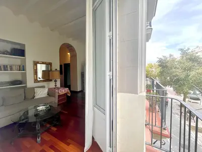 a living room with a couch and a balcony at Eva Recommends Porvenir Apartment in Jerez de la Frontera