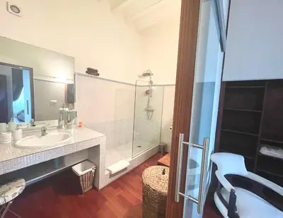 a bathroom with a sink and a glass shower at Eva Recommends Porvenir Apartment in Jerez de la Frontera