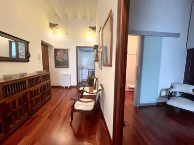 a living room with a wooden floor and a couch at Eva Recommends Porvenir Apartment in Jerez de la Frontera