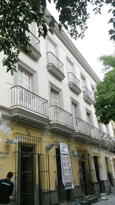 a man standing in front of a building at Eva Recommends Porvenir Apartment in Jerez de la Frontera