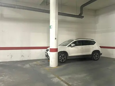 a white car parked in a parking garage at Eva Recommends Porvenir Apartment in Jerez de la Frontera