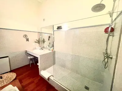 a bathroom with a glass shower and a sink at Eva Recommends Porvenir Apartment in Jerez de la Frontera