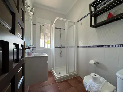 a bathroom with a shower and a toilet and a sink at El Mirador de Bellavista in Conil de la Frontera