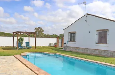 a house with a swimming pool next to a building at Casa con piscina 92 in Conil de la Frontera