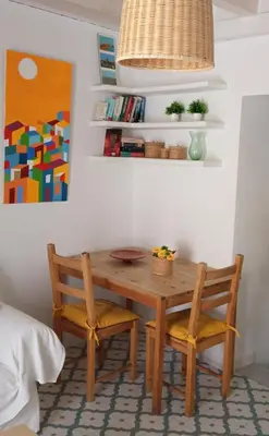 a dining room table with two chairs and a table at Sagasta Apartments in Cádiz