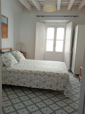 a bedroom with a bed and a window at Sagasta Apartments in Cádiz