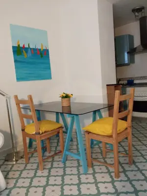 a dining room table with two chairs and a table at Sagasta Apartments in Cádiz