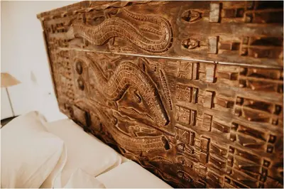 a wooden wall with an animal carving on it at Cortijo Bablou in Arcos de la Frontera
