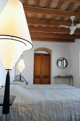 a bedroom with a bed with a lamp on it at Cortijo Bablou in Arcos de la Frontera