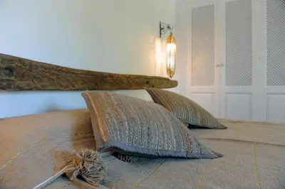 a bed with two pillows on top of it at Cortijo Bablou in Arcos de la Frontera