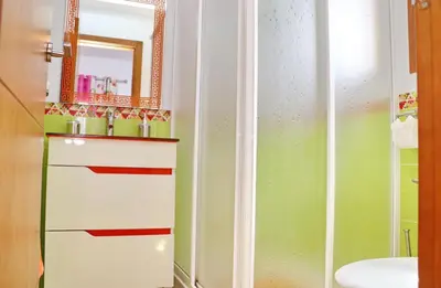 a bathroom with a sink and a mirror at Casa Independiente Conil in Conil de la Frontera