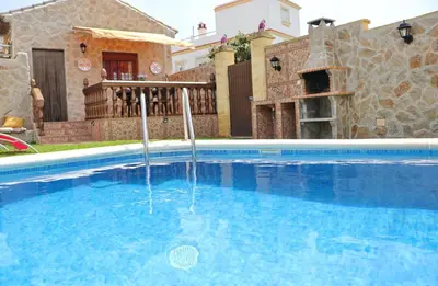 a swimming pool in front of a house at Casa Independiente Conil in Conil de la Frontera