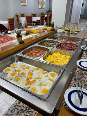 a buffet line with eggs and other breakfast foods at Hotel Trafalgar in Jerez de la Frontera