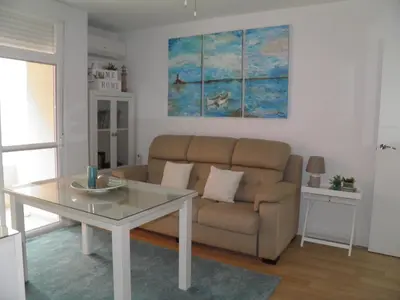 a living room with a couch and a table at Apartamento Playa100m in Sanlúcar de Barrameda