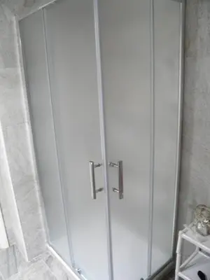 a shower with a glass door in a bathroom at Apartamento Playa100m in Sanlúcar de Barrameda