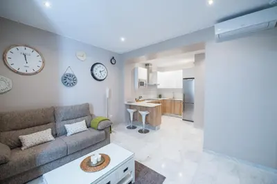a living room with a couch and a kitchen at Sagasta 13 in Cádiz
