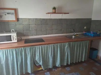 a kitchen counter with a sink and a microwave at Los Duendes in El Puerto de Santa María