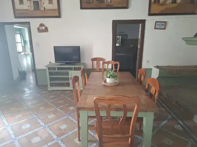 a dining room with a wooden table and chairs at Los Duendes in El Puerto de Santa María