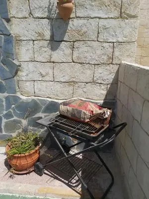 a grill with a bag on it next to a wall at Los Duendes in El Puerto de Santa María