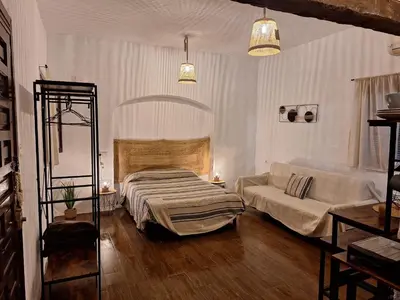 a living room with a bed and a couch at Los Duendes in El Puerto de Santa María