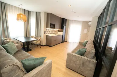 a living room with a couch and a table at Hotel y Apartamentos Diufain in Conil de la Frontera