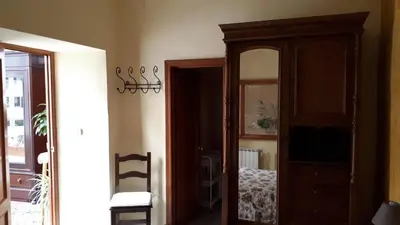 a room with a cabinet and a mirror at Hostal Manolo in El Puerto de Santa María