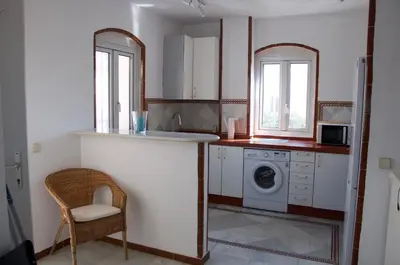 a kitchen with a sink and a washing machine at Ático Playa Muralla in El Puerto de Santa María