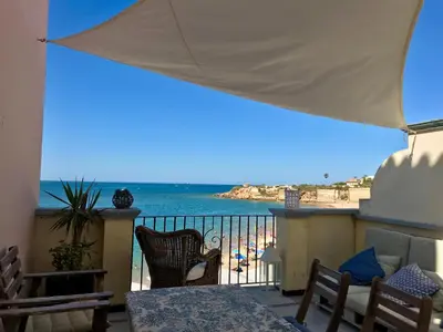 a balcony with a view of the beach and the ocean at Ático Playa Muralla in El Puerto de Santa María