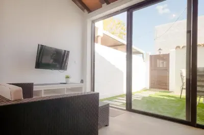 an open living room with a sliding glass door at Real de La Barrosa 46 in Chiclana de la Frontera