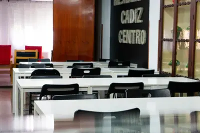 a room with white tables and black chairs at Residencia Universitaria Cadiz Centro in Cádiz