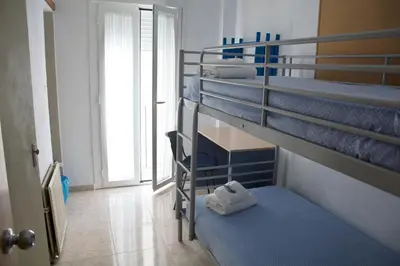 two bunk beds in a room with towels on them at Residencia Universitaria Cadiz Centro in Cádiz