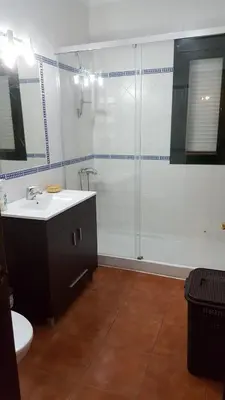 a bathroom with a shower and a sink and a toilet at Chalet Las Adelfas Chaparrillo in Conil de la Frontera