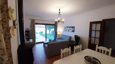 a living room with a couch and a table at Chalet Las Adelfas Chaparrillo in Conil de la Frontera