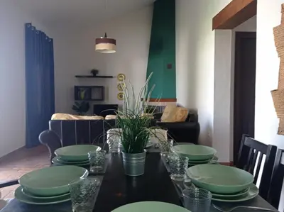 a dining room with a table with green plates at Chalet La Primera Piedra in Conil de la Frontera