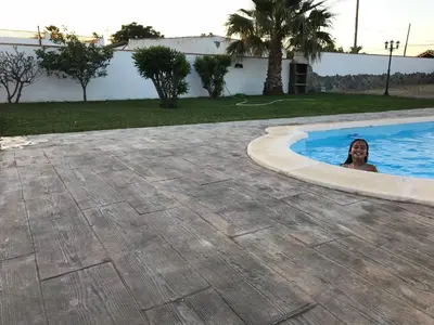 a woman is in a swimming pool at Chalet La Primera Piedra in Conil de la Frontera