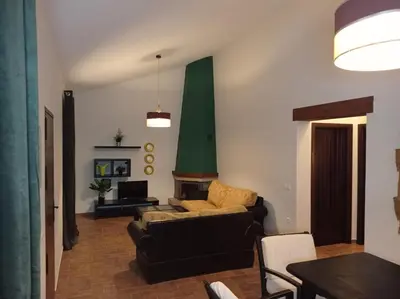 a living room with a couch and a fireplace at Chalet La Primera Piedra in Conil de la Frontera
