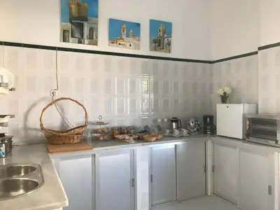 a kitchen with white cabinets and a sink at Alojamiento Rural La Mejora in Conil de la Frontera