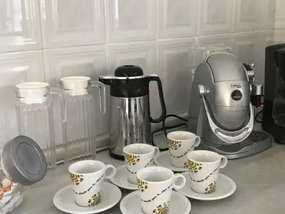 a group of cups on a counter with a coffee maker at Alojamiento Rural La Mejora in Conil de la Frontera