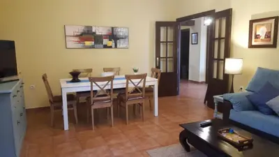 a living room with a table and chairs and a couch at Chalet Roche - Pilahito in Conil de la Frontera