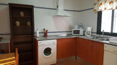 a kitchen with a washing machine and a sink at Chalet Roche - Pilahito in Conil de la Frontera