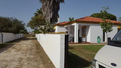 a white fence in front of a white house at Chalet Roche - Pilahito in Conil de la Frontera