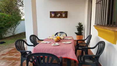 a table with a red and white checkered table cloth at Chalet Roche - Pilahito in Conil de la Frontera