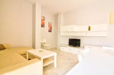a living room with a couch and a table at Apartamentos Centro 1 El Puerto de Santa Maria in El Puerto de Santa María
