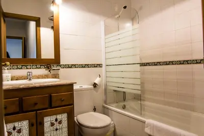 a bathroom with a toilet and a sink and a shower at Apartamentos Centro 1 El Puerto de Santa Maria in El Puerto de Santa María